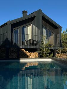 a house with a pool in front of it at Barnhouse Tatariv in Dobrovelychkivka