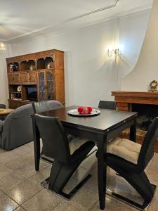 a dining table and chairs in a living room with a table at LUCINDA`S HOUSE in Braga