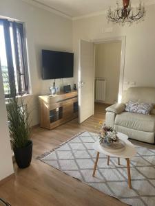 un salon avec un canapé et une télévision dans l'établissement Luxury Suite come al Four Seasons, à Paola