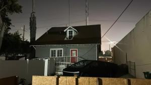 a small house with a red door and a black roof at Vernon Vibes in Los Angeles