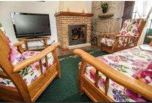 a living room with two beds and a fireplace at Casa rural La rectoral in Areas