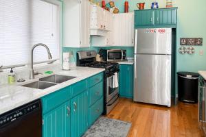 a kitchen with blue cabinets and a white refrigerator at Cherry Fish North in Beulah