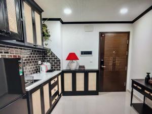 a kitchen with a red lamp on the counter at The Levana Home Saigon in Ho Chi Minh City