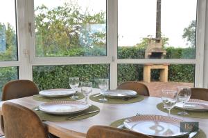 a table with chairs and plates and glasses on it at Le Gîte de Mellonia - 7 chambres in Pouzauges