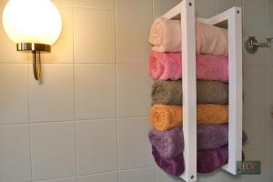 a bunch of towels on a rack in a bathroom at Le Gîte de Mellonia - 7 chambres in Pouzauges +41 photos