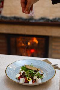 a plate of food with a salad on a table at Hotel Belvedere in Predeal +35 photos