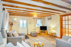 a living room with a couch and a tv at 2 Bed in Betws-y-Coed oc-84026 in Penmachno