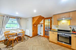 a kitchen with a table and a dining room at 2 Bed in Betws-y-Coed oc-84026 in Penmachno +11 photos