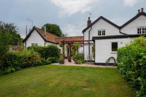 een wit huis met een tuin ervoor bij 3 Bed in Letheringham oc-pclet in Kettleburgh