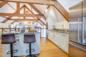 a kitchen with white cabinets and steel appliances at 6 Bed in Blaencwm oc-t32688 in Blaencwm