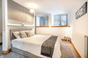 a bedroom with a large bed and two windows at 6 Bed in Blaencwm oc-t32688 in Blaencwm