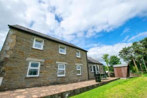 een stenen huis met een gazon ervoor bij 3 Bed in Swansea Valley oc-80031 in Pontardawe