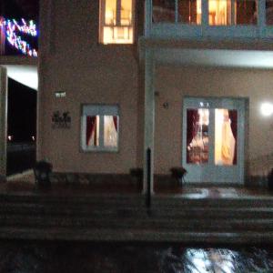 a building at night with lights in the windows at O toxal in Monforte de Lemos