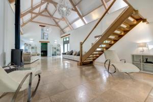een grote woonkamer met een trap en stoelen bij 4 Bed in Drewsteignton oc-bc2408 in Drewsteignton