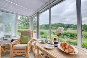 a breakfast room with a table and a window at 2 Bed in Dulverton oc-badger in Dulverton