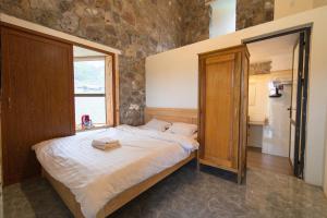 a bedroom with a large bed in a room with a window at Thào Gia Homestay Mèo Vạc in Ha Giang
