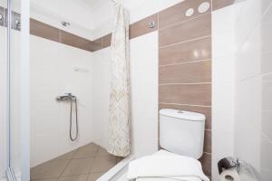 a bathroom with a toilet and a shower at Villa Sequoia Yellow in Barbati +12 photos