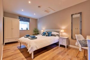 a bedroom with a large bed and a mirror at Finest Retreats - The Asparagus Shed in Howell
