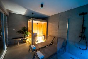 a room with a couch and a glass shower at Villa Oasis Aria in Mostar