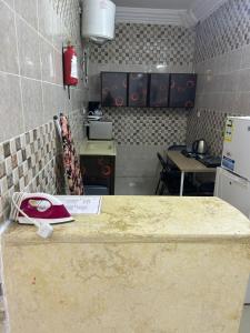 eine Küche mit einer Arbeitsplatte in einem Raum in der Unterkunft شقق ضيافة المصيف للشقق المخدومة in Ta'if