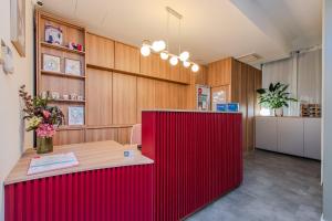 a red counter in a room with wooden walls at Garni Hotel VIRGO in Bratislava