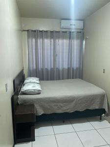 Ένα ή περισσότερα κρεβάτια σε δωμάτιο στο Casa de Praia Navegantes - 100 metros do mar