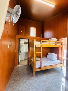 a bunk bed in a room with a fan at Thào Gia Homestay Mèo Vạc in Ha Giang +29 photos