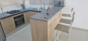 a kitchen with a counter with a sink and a stove at Residence fedi 12 in Monastir