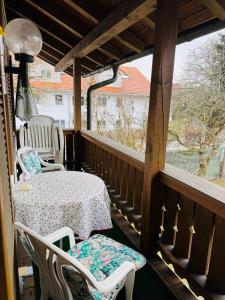 a porch with a table and chairs and a window at Ferienwohnung Nika in Bad Reichenhall +9 photos