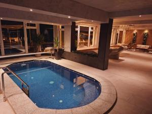 a swimming pool in the middle of a house at CASA 9 - villa & spa in Eşelniţa
