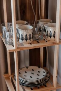 a wooden shelf with plates and glasses on it at Sadyba u Halyny in Bukovel +87 photos
