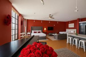 a room with red walls and a bed and roses at The Red Room - Double King Bed - Grand Piano in Dallas