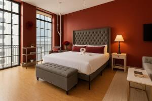 a bedroom with a large bed and a chair at The Red Room - Double King Bed - Grand Piano in Dallas