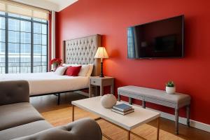 a red bedroom with two beds and a flat screen tv at The Red Room - Double King Bed - Grand Piano in Dallas