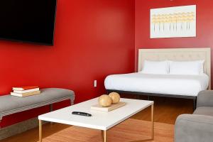 a hotel room with a bed and a table with a coffee table at The Red Room - Double King Bed - Grand Piano in Dallas