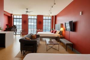a large living room with red walls and a couch at The Red Room - Double King Bed - Grand Piano in Dallas +5 photos