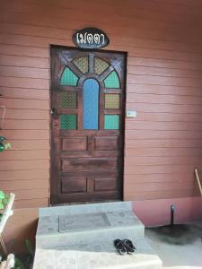 a door to a house with a mattress in front of it at Huan Janto Homestay - Metta in Chiang Mai