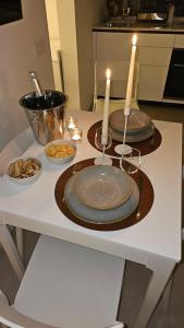 a table with two candles and plates on it at Interno 8 in Padova