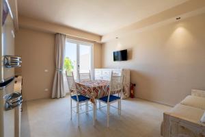 une salle à manger avec une table et des chaises et une fenêtre dans l'établissement Nostalgia, à Tortolì
