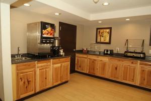a kitchen with wooden cabinets and a counter top at Expo Inn in Tulsa