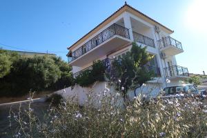 a white house with balconies on the side of it at Finikounda in Finikounta