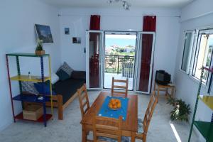 a living room with a table and chairs and a couch at Finikounda in Finikounta