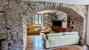 ein Wohnzimmer mit einer Steinmauer in der Unterkunft Ô Coeur des Liens in Saint-Seine-lʼAbbaye