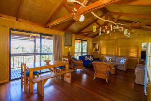 a living room with a table and a couch at Bimbimbi • Coastal Hideaway • 2BR 1770 Views in Seventeen Seventy