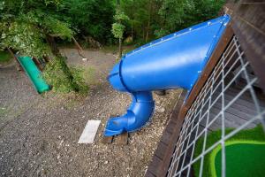 a playground with a blue slide on a fence at 5 Bedroom - Four En-Suite & Bunk Loft w/half bath in Stephens Gap +155 photos