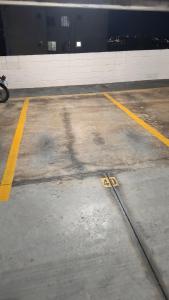 an empty parking lot with a shadow of a building at Apartamento Aconchegante-1105 in Itatiba