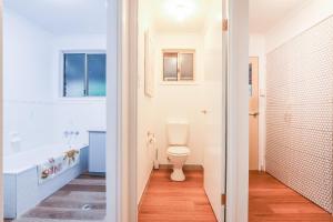 a bathroom with a toilet and a tub and a sink at Cake By The Ocean in Seventeen Seventy +55 photos
