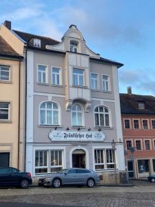a building with cars parked in front of it at Hotel Fränkischer Hof in Kitzingen