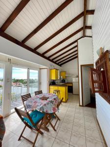a kitchen and dining room with a table and chairs at Le Chalet in Saint-François
