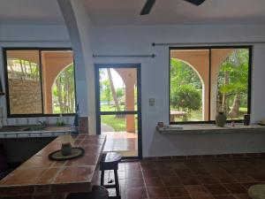 a dining room with a table and windows at El Diamante - Playa Hermosa in Playa Hermosa